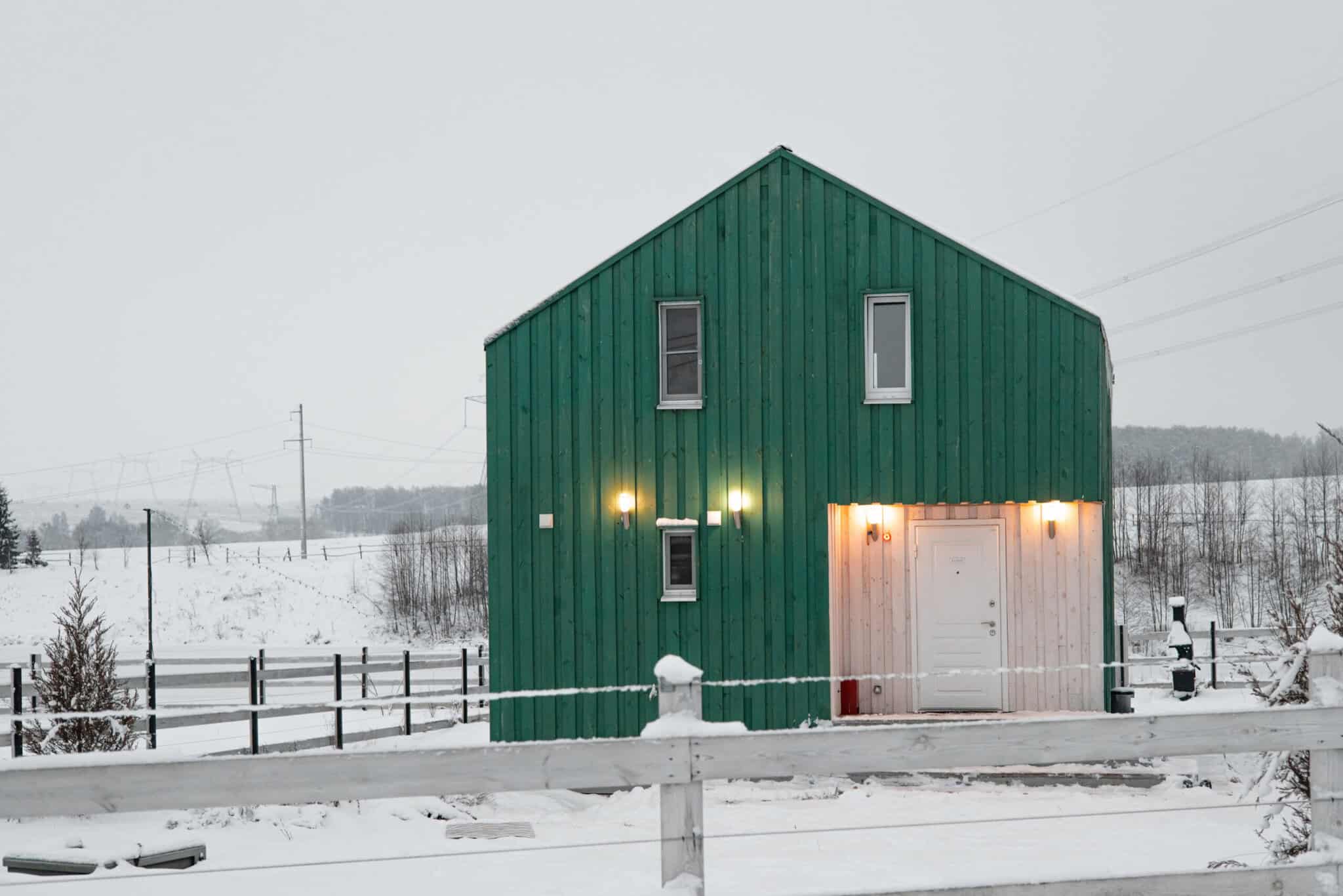 Modern wood house in the Scandinavian style with different color , winter day in village side view