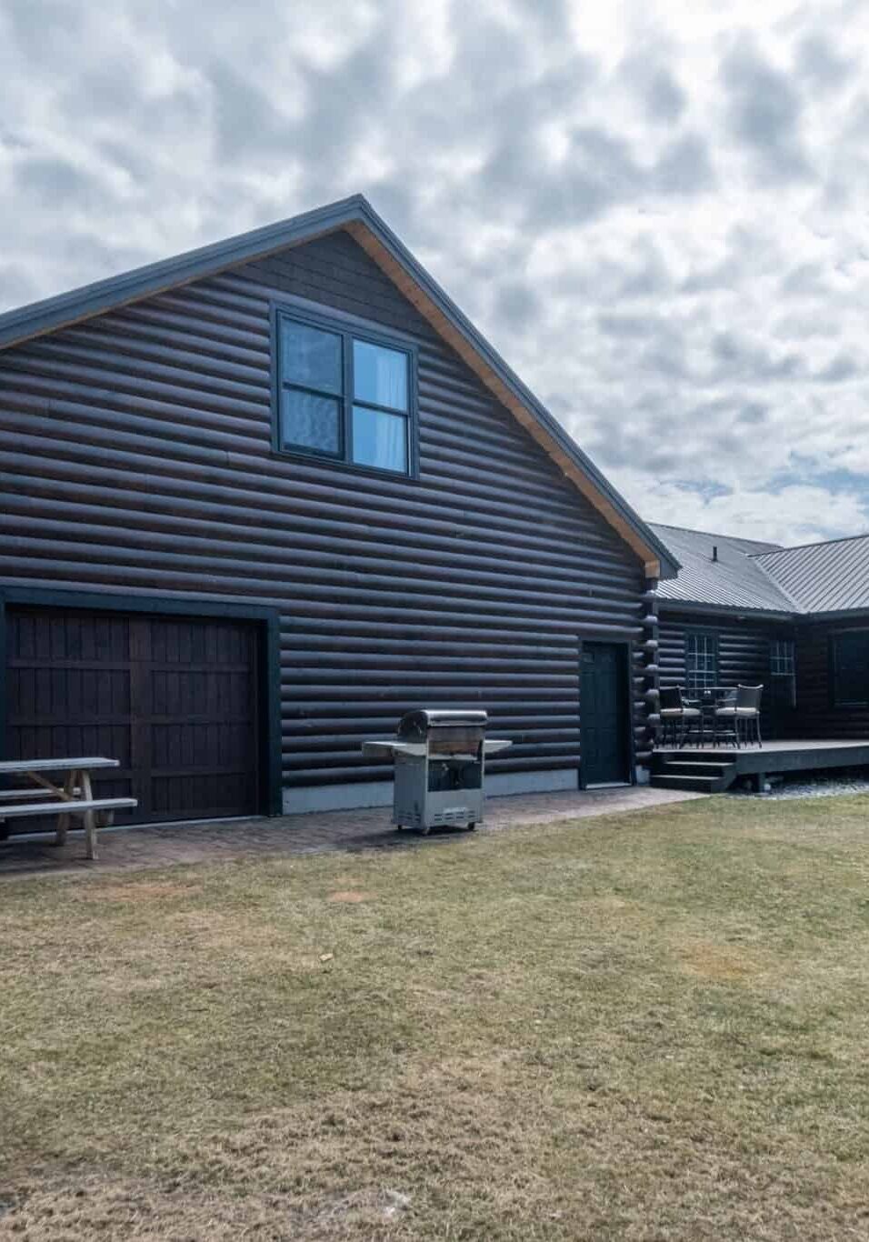 Beautiful contemporary rustic log cabin on a rural field in the mountains A beautiful contemporary rustic log cabin on a rural field in the mountains